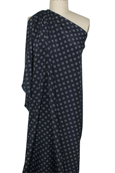 Silk crepe de chine in navy with grommet-shaped print