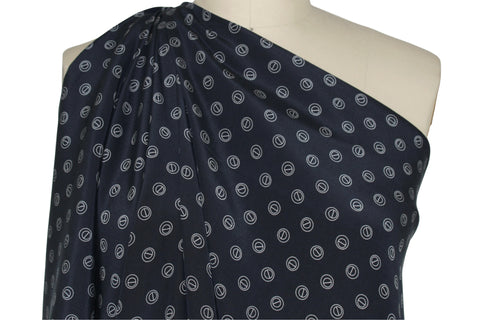 Silk crepe de chine in navy with grommet-shaped print