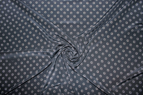 Silk crepe de chine in navy with grommet-shaped print