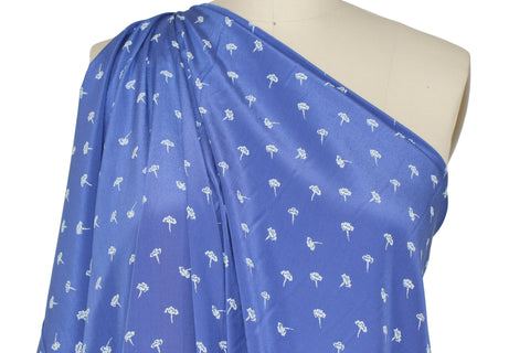 0scar silk crepe de chine in a dainty floral pattern on blue background