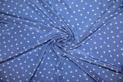 0scar silk crepe de chine in a dainty floral pattern on blue background