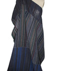 A dark navy blue patchwork fabric with vertical striped patterns in blue, green, and red.