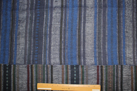 A dark navy blue patchwork fabric with vertical striped patterns in blue, green, and red.