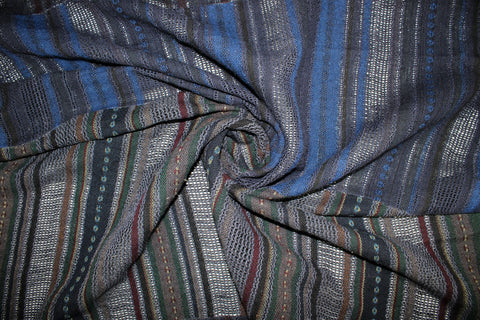 A dark navy blue patchwork fabric with vertical striped patterns in blue, green, and red.