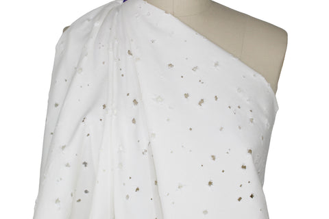 Distressed white denim fabric