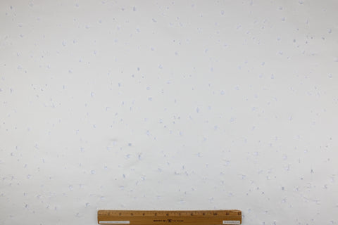 Distressed white denim fabric