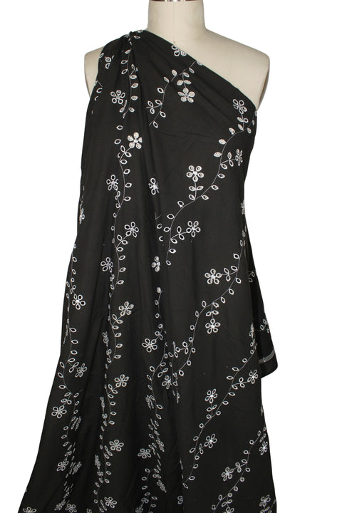 Floral vines eyelet on dark brown cotton fabric