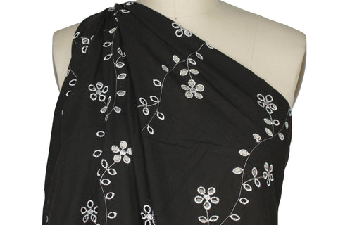 Floral vines eyelet on dark brown cotton fabric