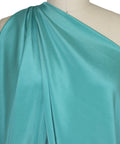 4 ply stretch silk crepe closeup on mannequin teal turquoise