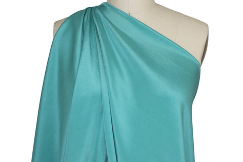 4 ply stretch silk crepe closeup on mannequin teal turquoise