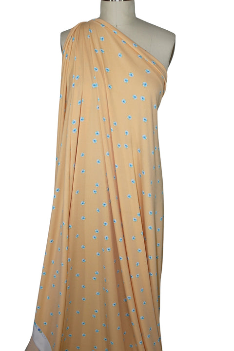 ITY jersey with blue flowers on a creamsicle ground. 