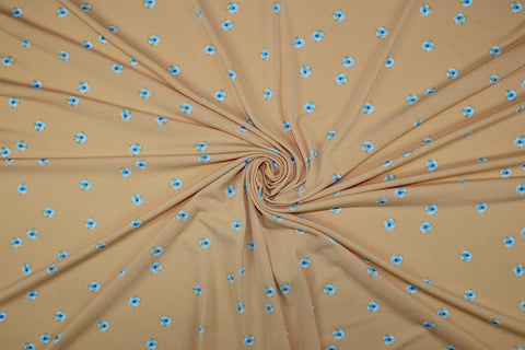 ITY jersey with blue flowers on a creamsicle ground. 