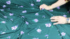 Flower print rayon jersey in purple on green