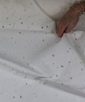 Distressed white denim fabric
