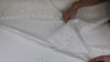 Distressed white denim fabric