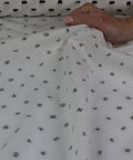 Italian cotton shirting with letters woven into it