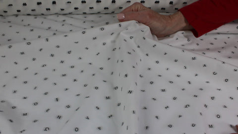 Italian cotton shirting with letters woven into it
